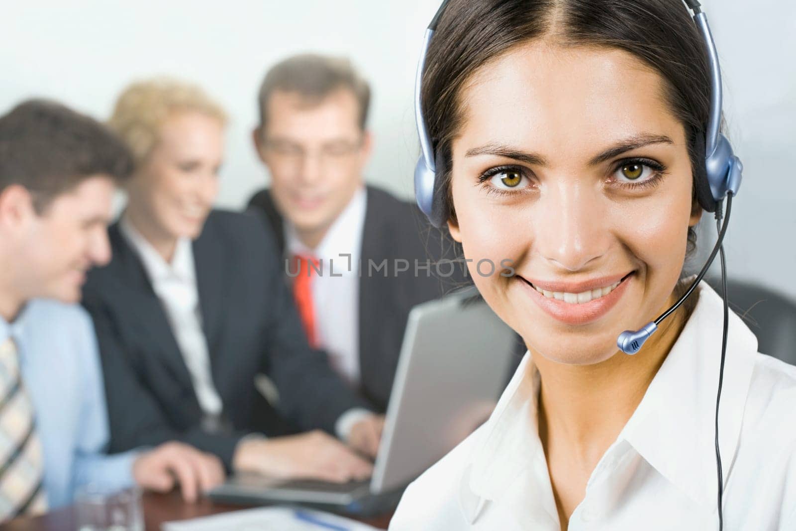 Portrait of pretty business woman with her team on the background