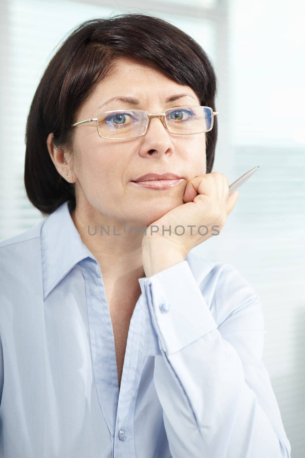 Mature businesswoman in eyeglasses looking at camera