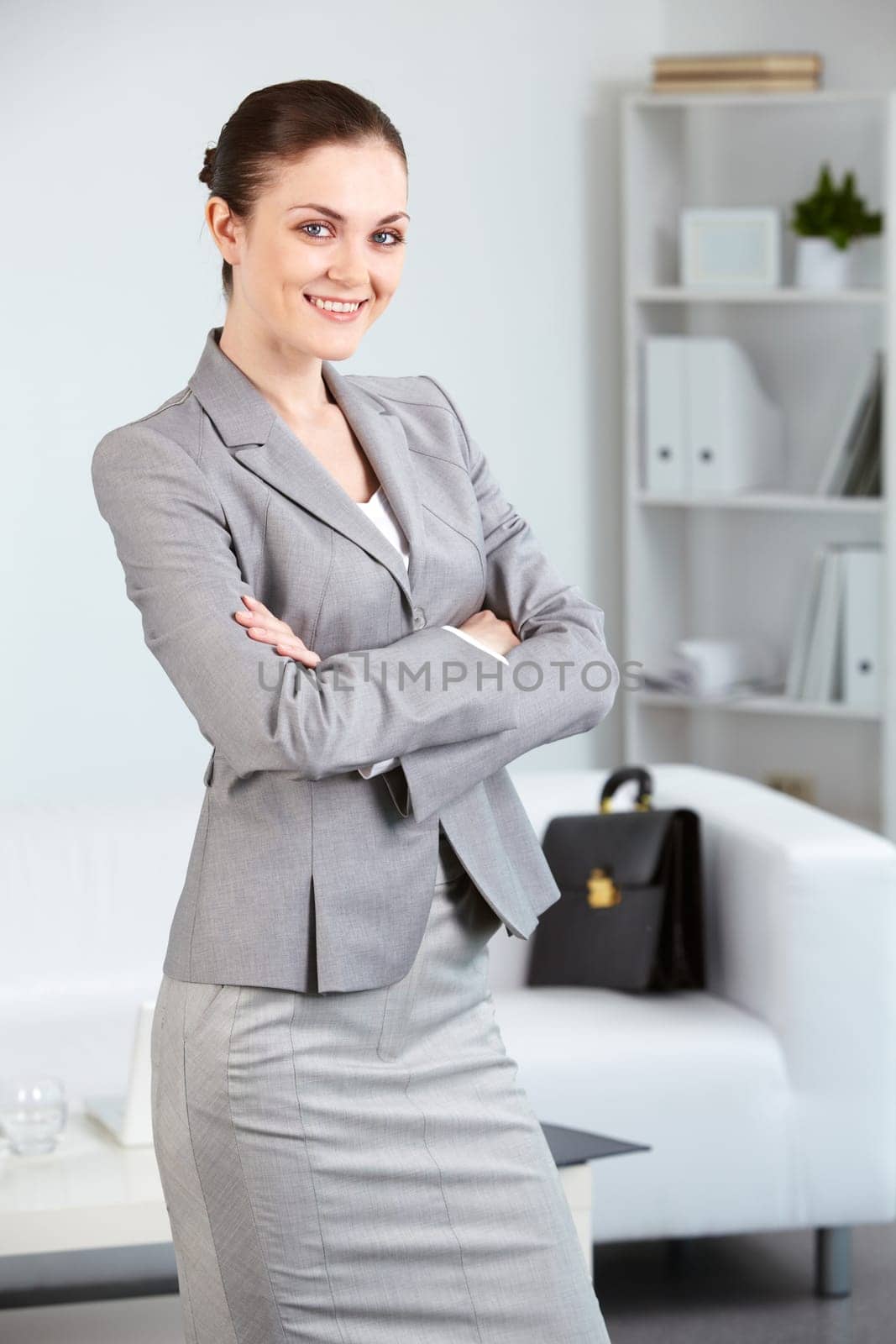 Portrait of smiling businesswoman looking at camera in office