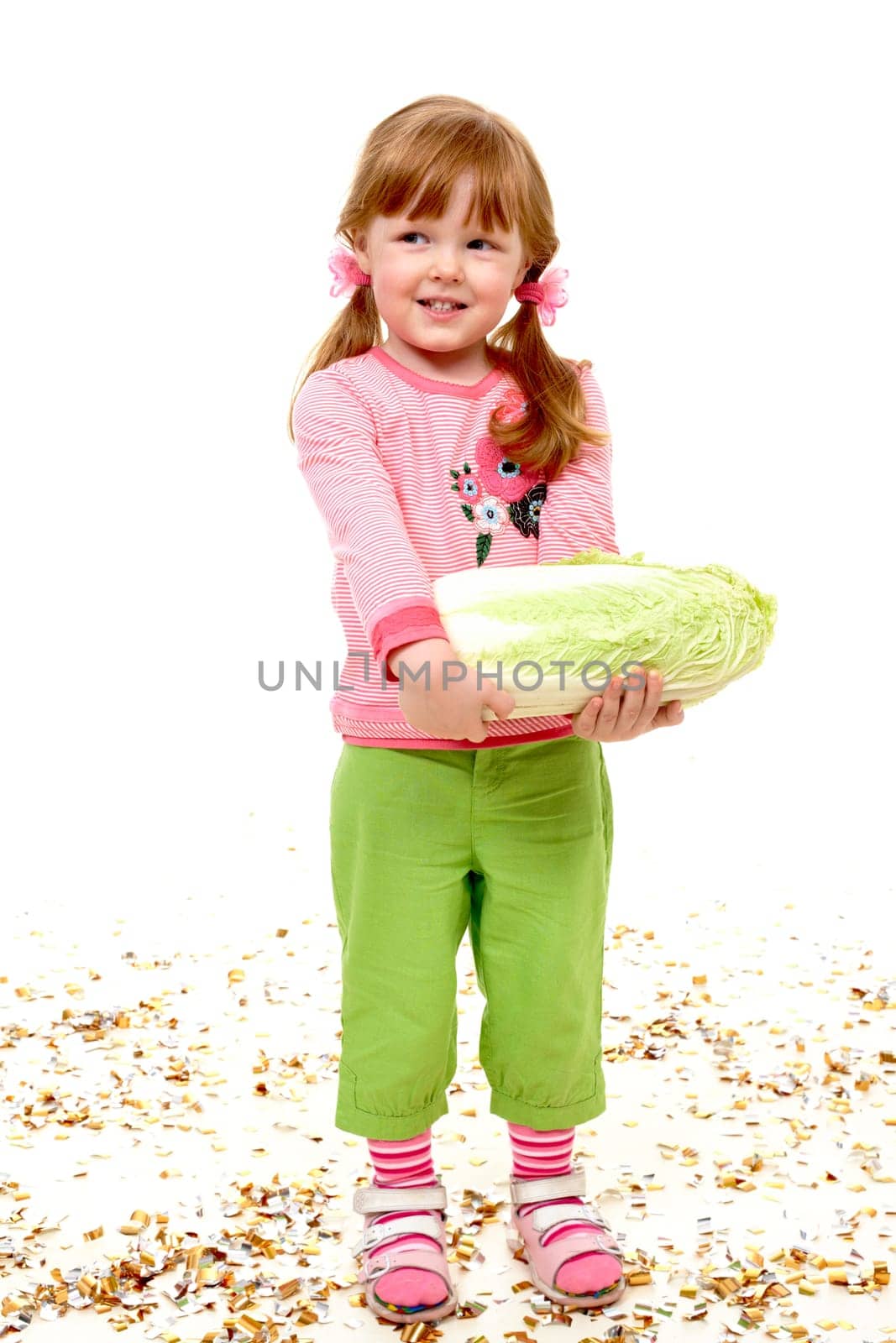 Portrait of happy girl holding Chinese cabbage