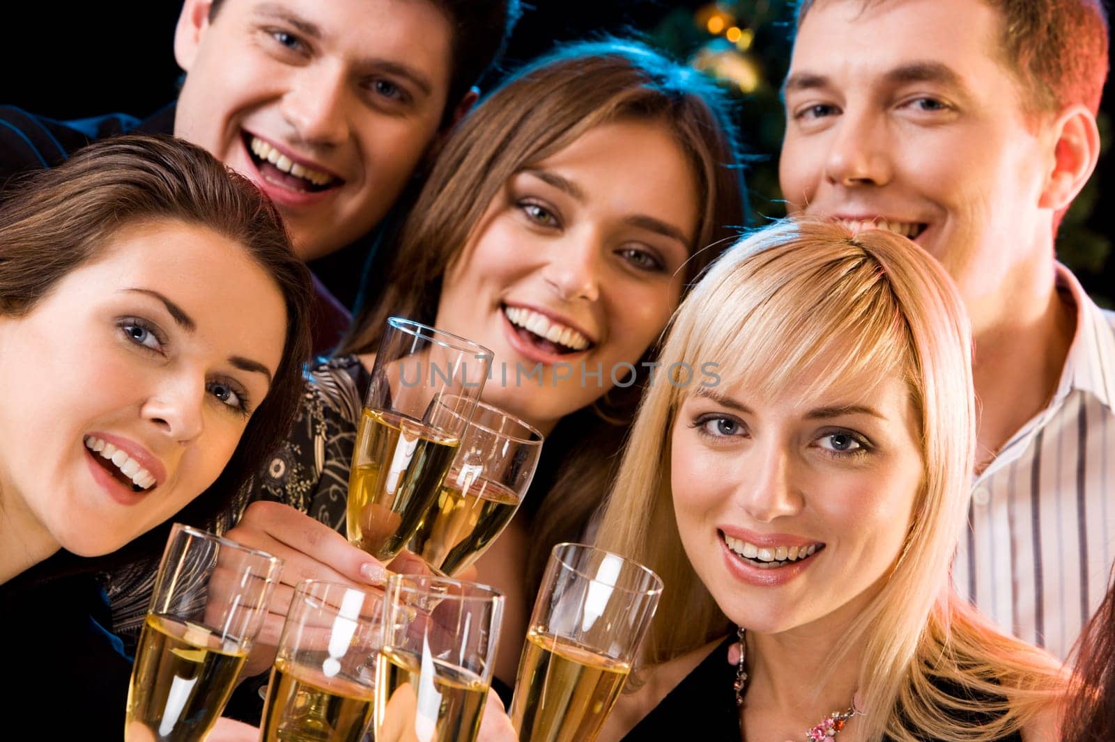 Portrait of smiling people holding cocktails and looking at camera
