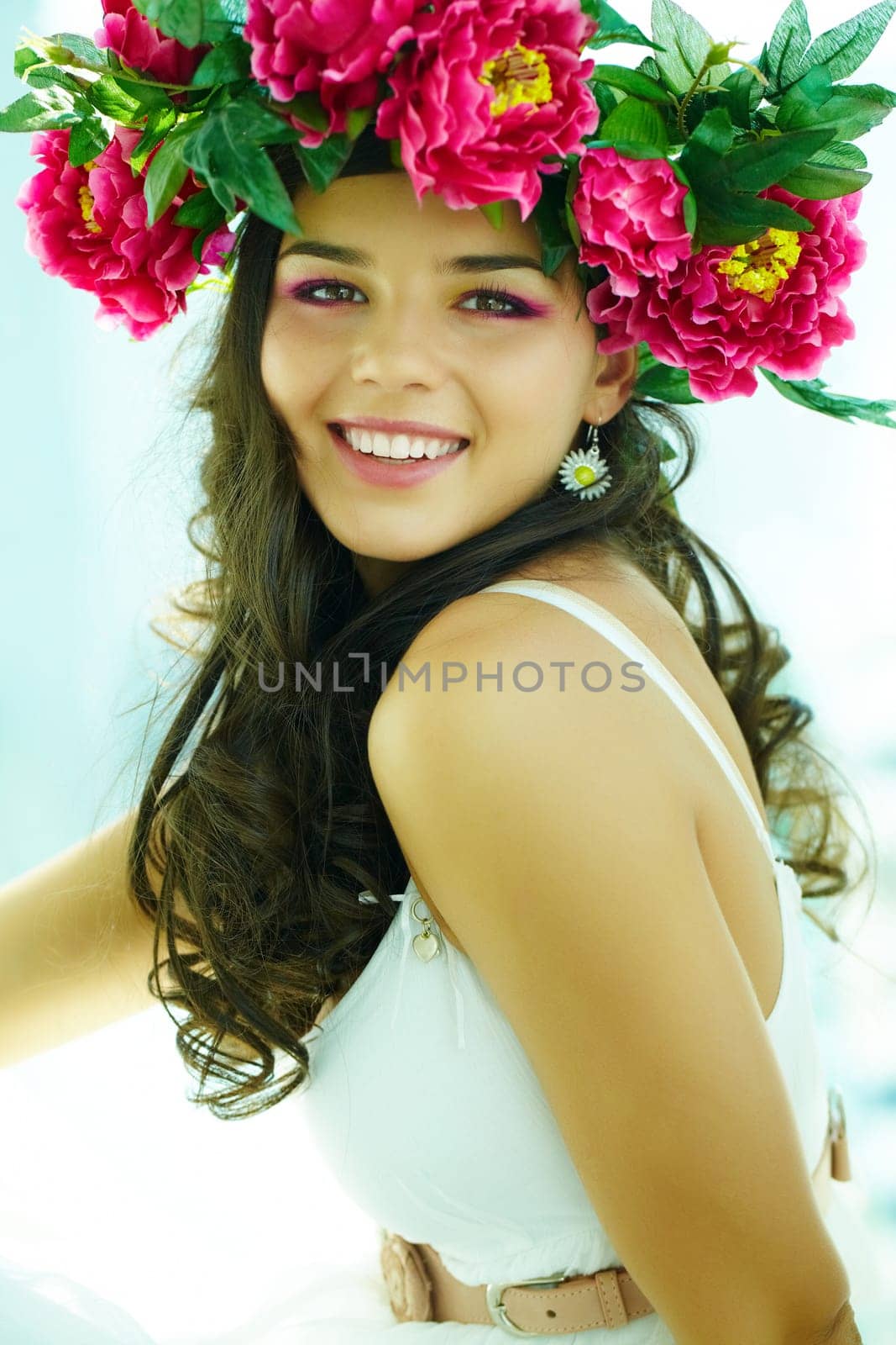 Beautiful woman in floral wrath looking at camera