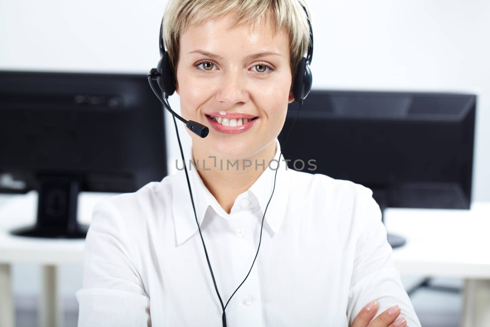 Portrait of beautiful woman with headset looking at camera and smiling