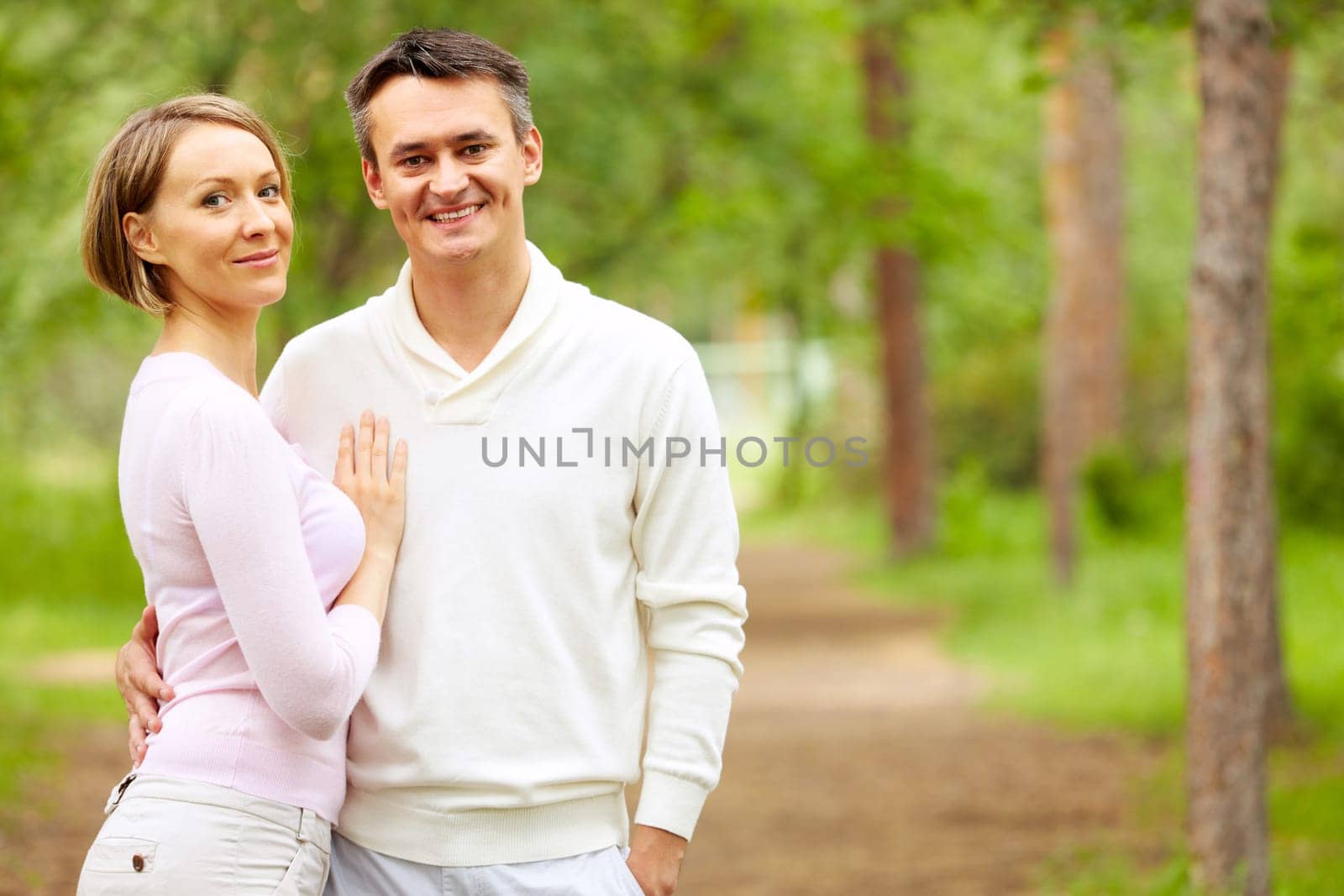 Portrait of young happy couple looking at camera outdoors