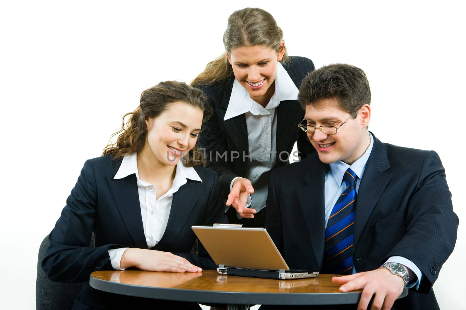 Portrait of confident business team gathered together at meeting and looking at the monitor of laptop with smiles