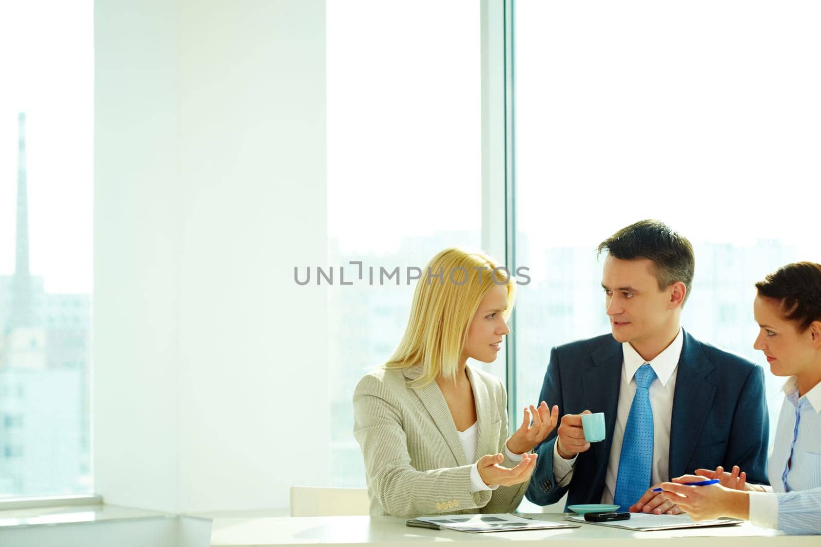 Smart woman explaining her idea to colleagues in office