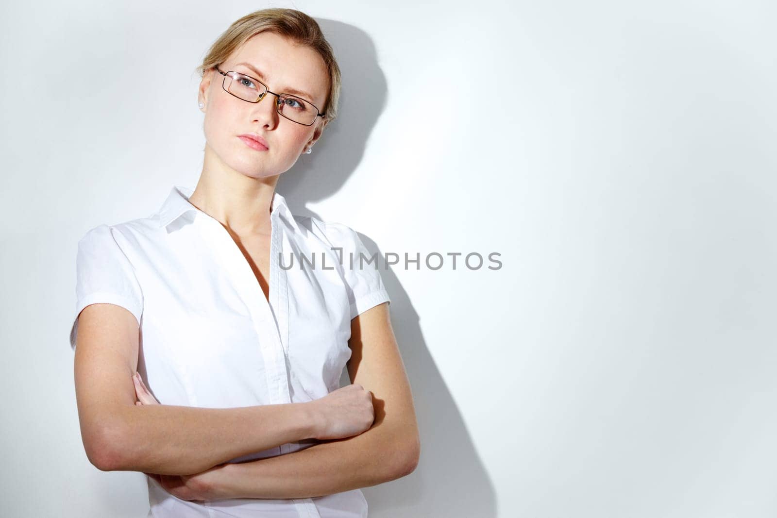 Portrait of young pensive woman isolated on white background