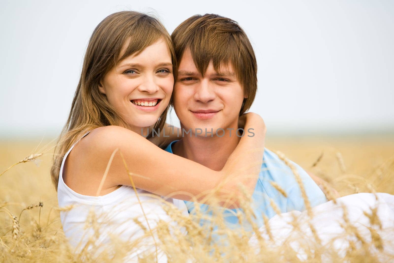 Image of handsome man and beautiful girl looking at camera