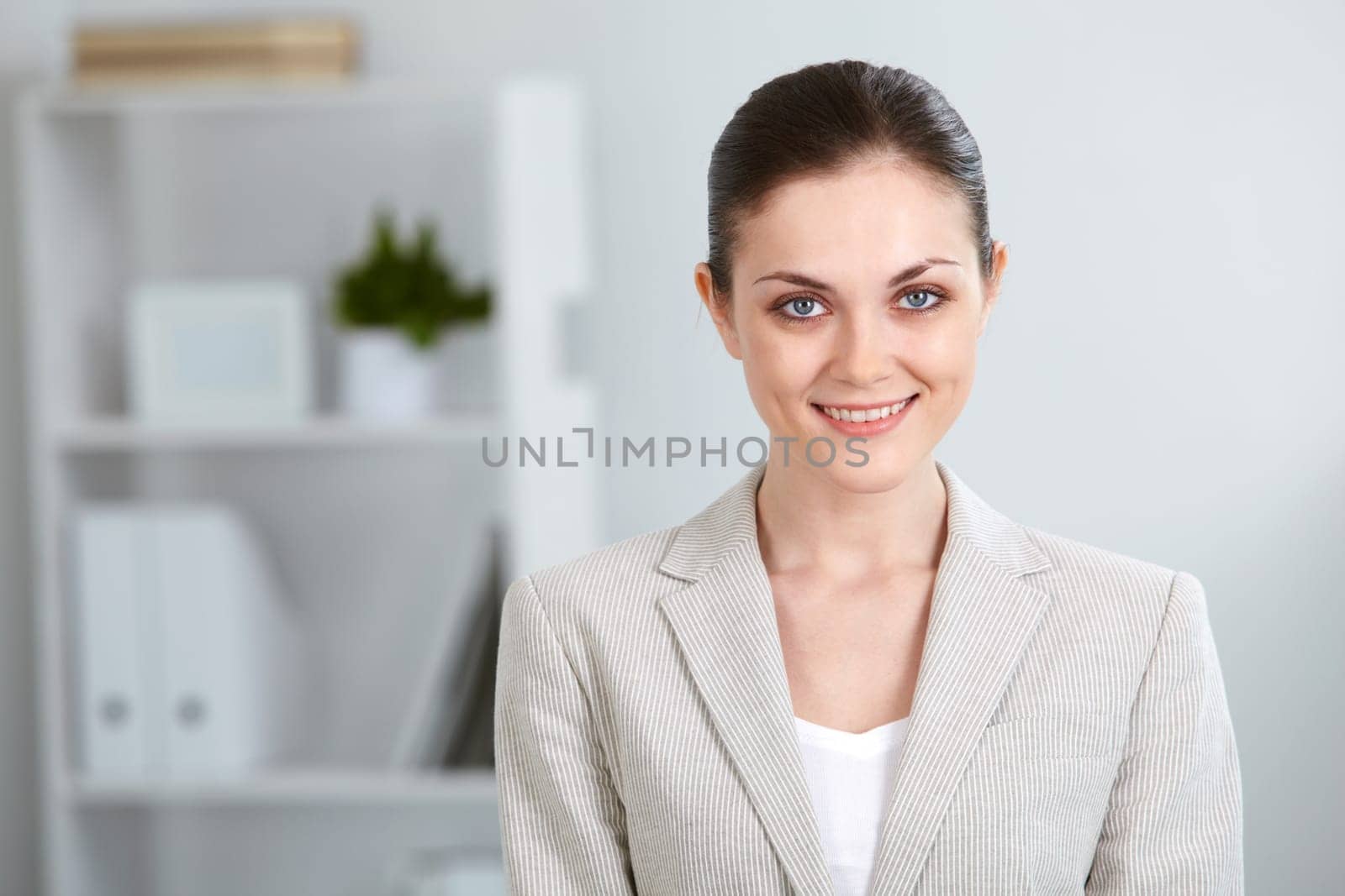 Portrait of successful businesswoman looking at camera with smile