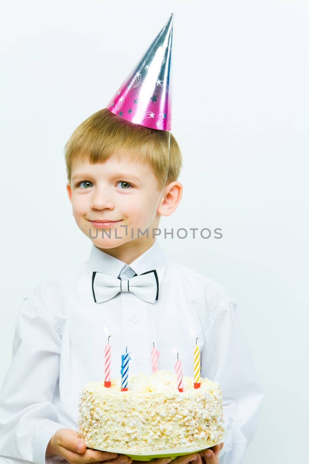 Portrait of diligent schoolboy looking at camera at his birthday