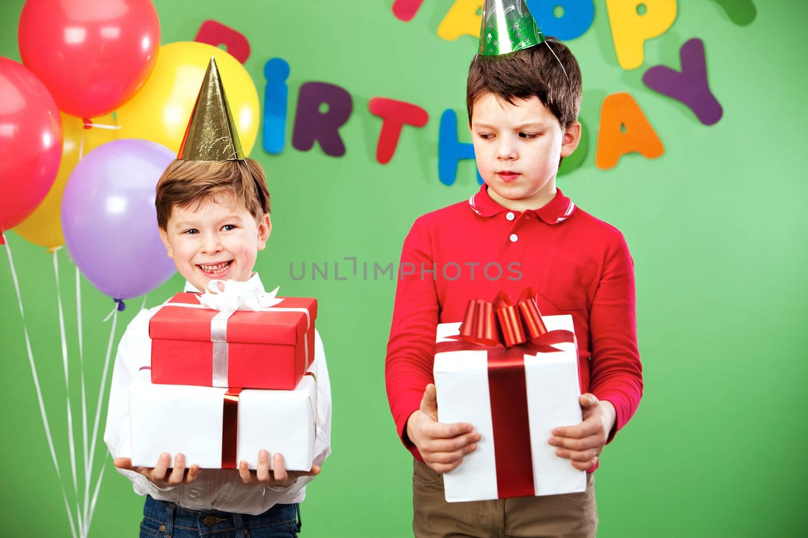 Portrait of two siblings on birthday party with giftboxes
