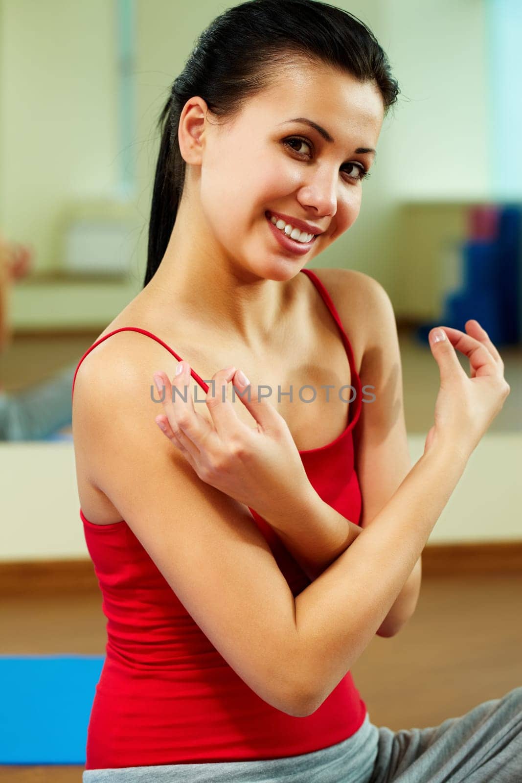 Portrait of happy girl meditating in gym