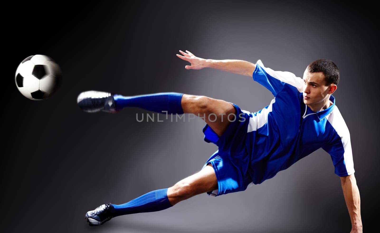 Image of soccer player doing flying kick with ball