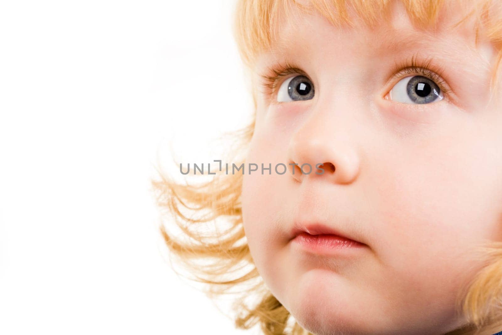 Photo of adorable child with grey eyes looking aside
