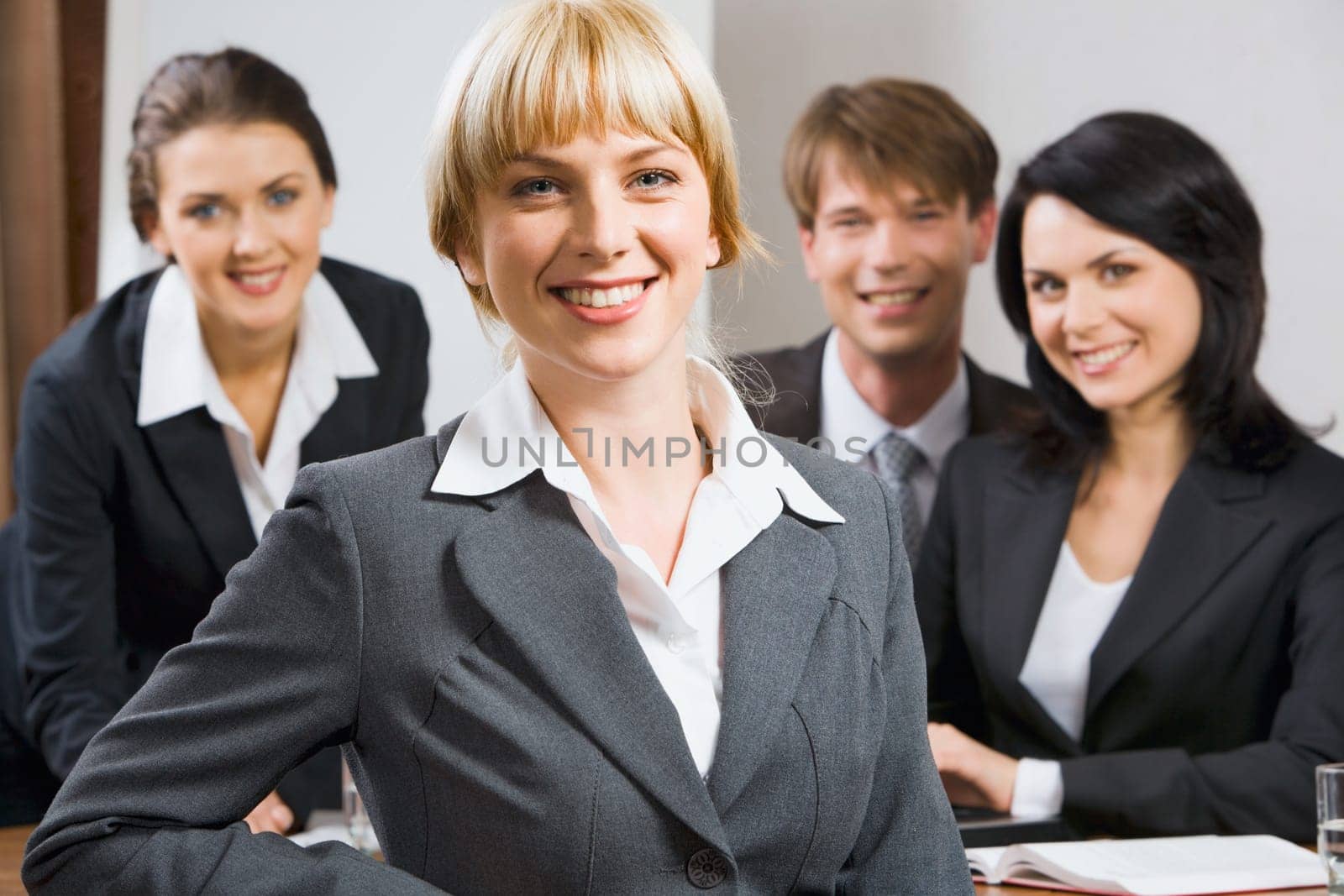 Female leader on the background of  her business team