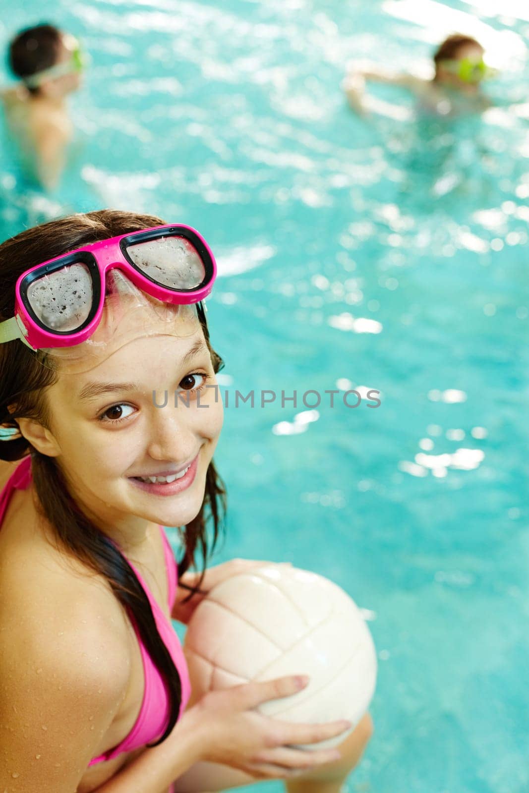 Photo of happy girl with ball smiling at camera