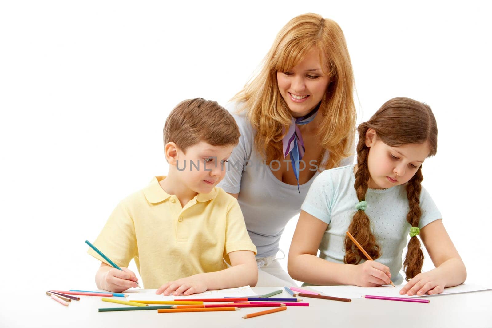 Portrait of children drawing pictures and teacher standing near