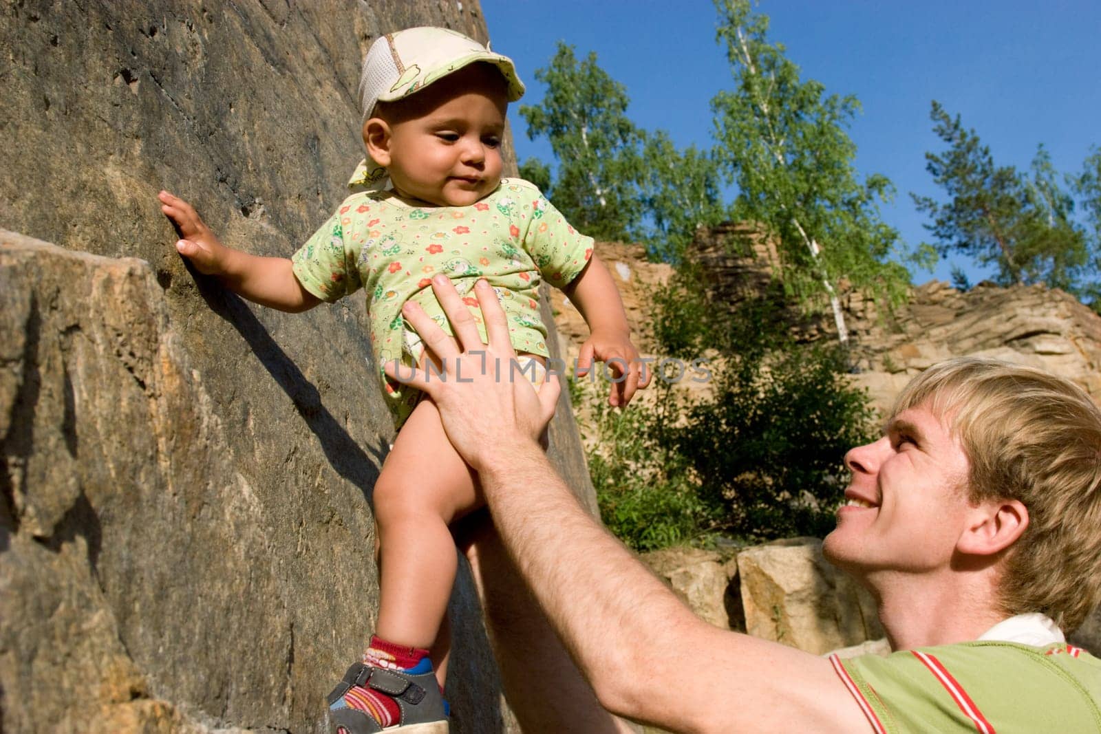 Photo of daddy teaching his son rock-climbing