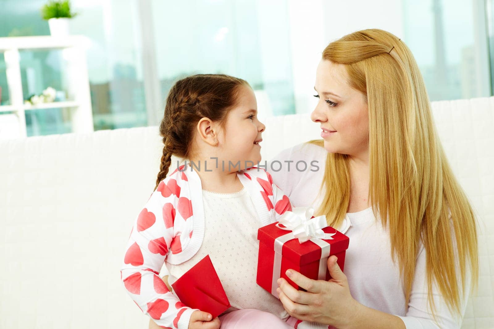 Happy mother and her daughter looking at one another