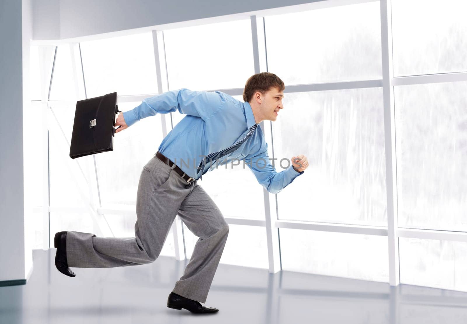 A running businessman with briefcase