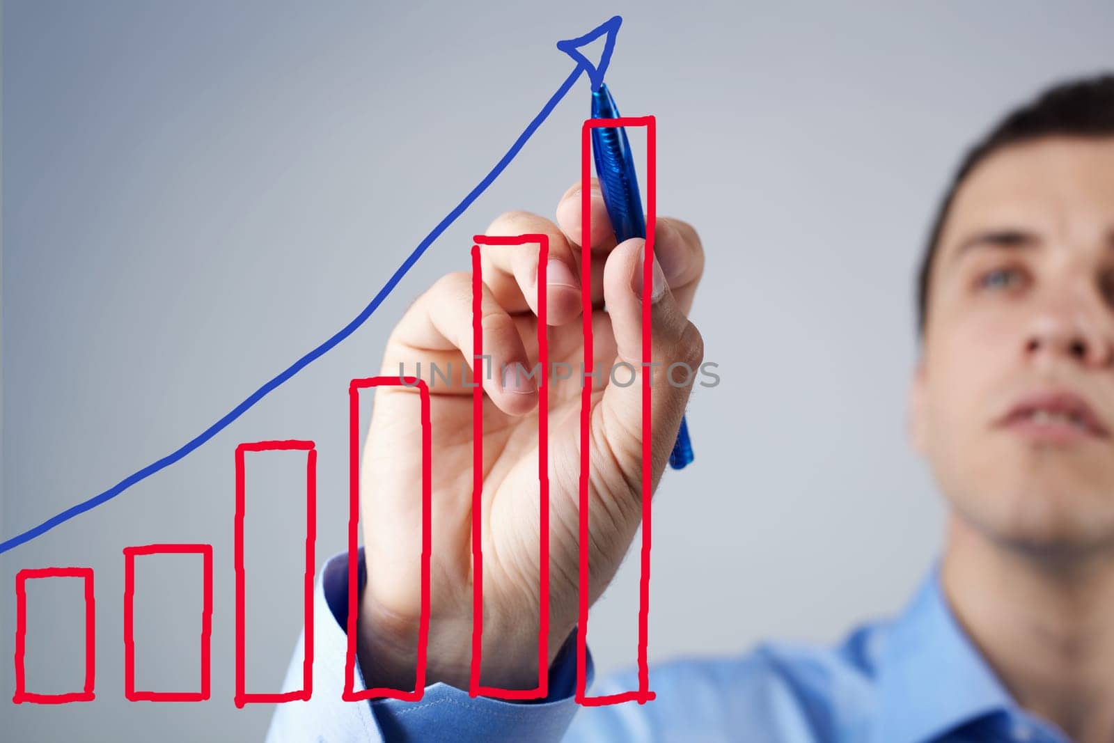 Close-up of businessman drawing success scheme