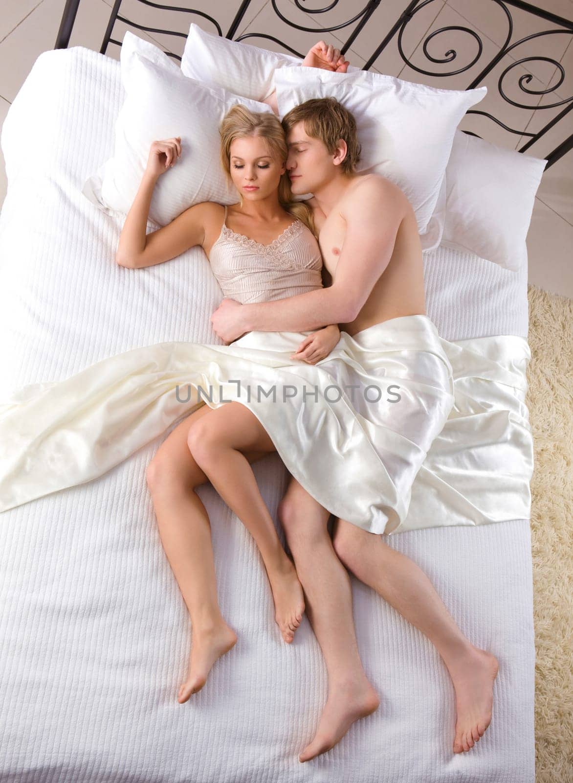 Photo of relaxed husband and wife sleeping together