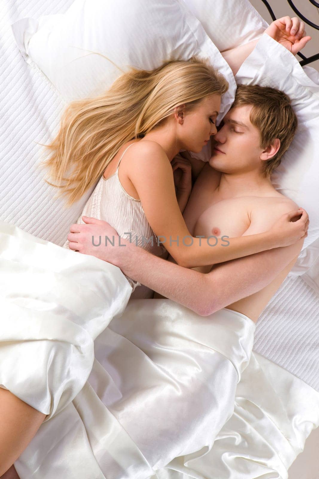 Photo of husband and wife embracing each other while sleeping