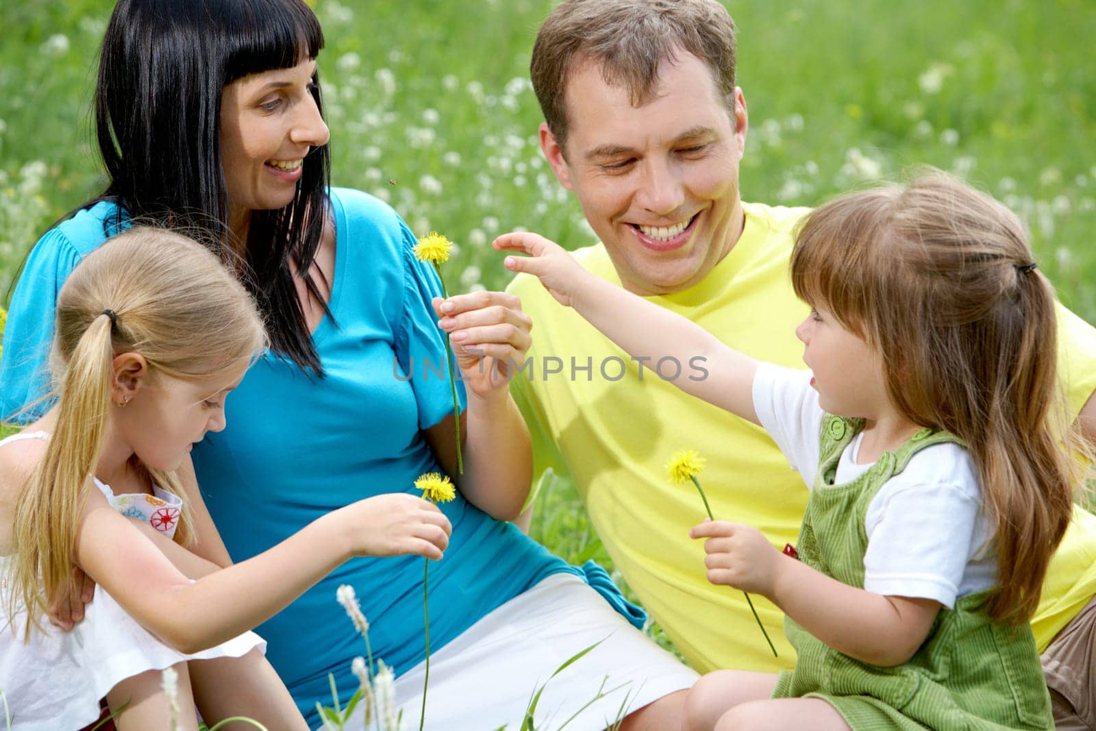 Portrait of happy family spending time outdoors in summer