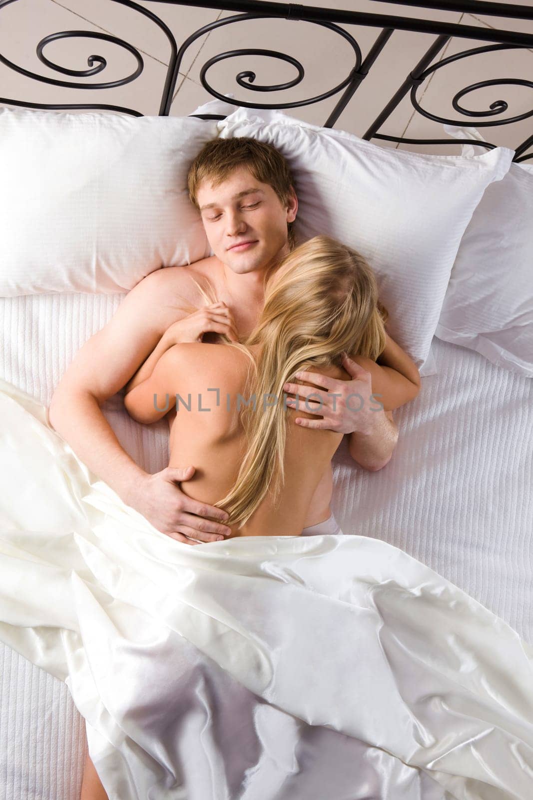 Photo of handsome man and his wife embracing during intimacy