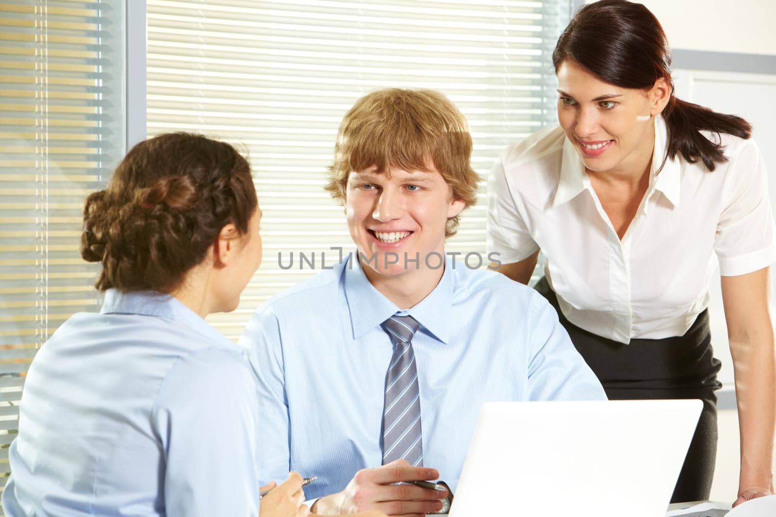 Portrait of friendly workteam discussing project in the office