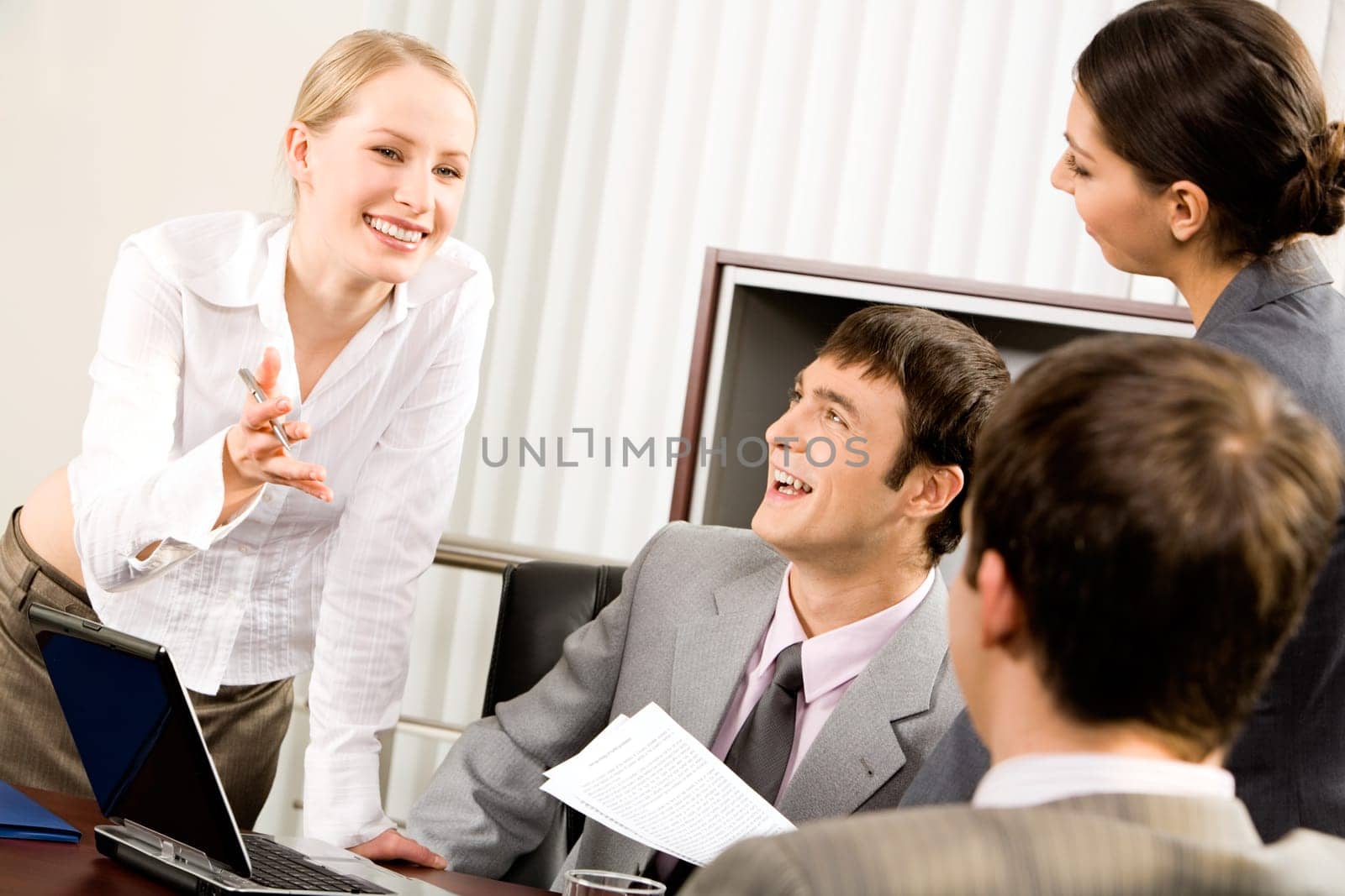 Portrait of business woman explaining her new working idea to co-workers in the office