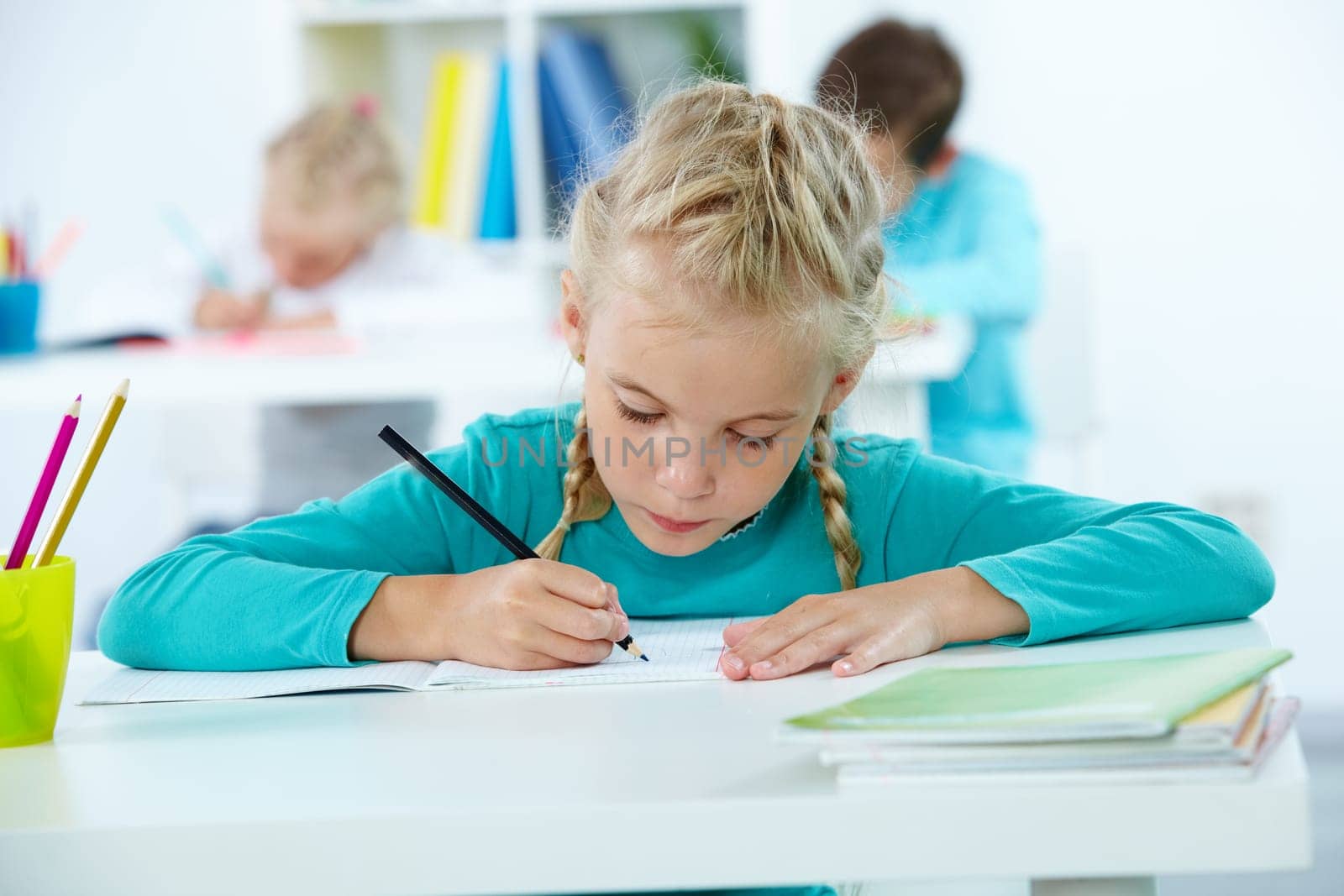Portrait of lovely girl drawing with classmates on background