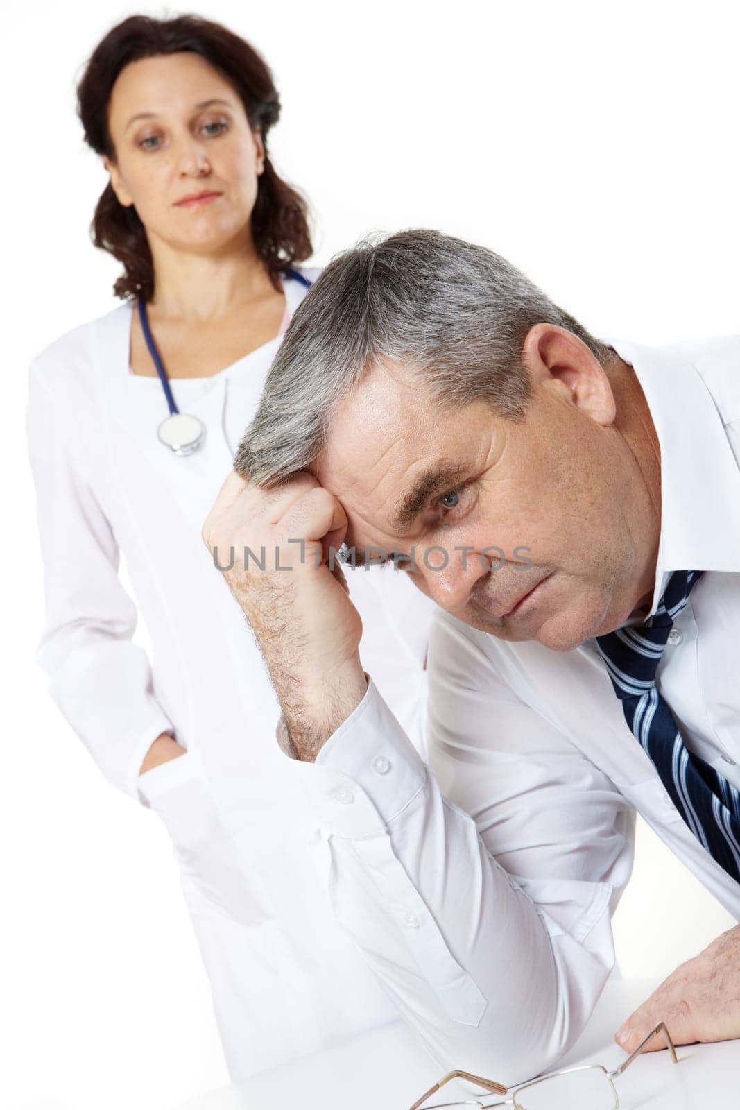 Portrait of a troubled senior man and a woman doctor