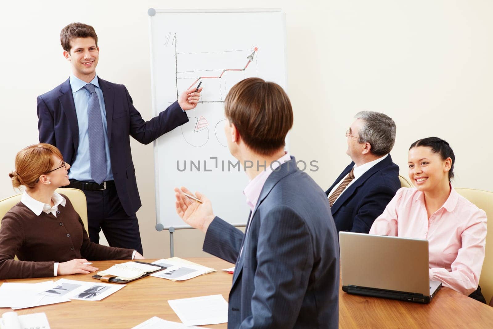 Two business partners speculating about idea during presentation in office in working environment