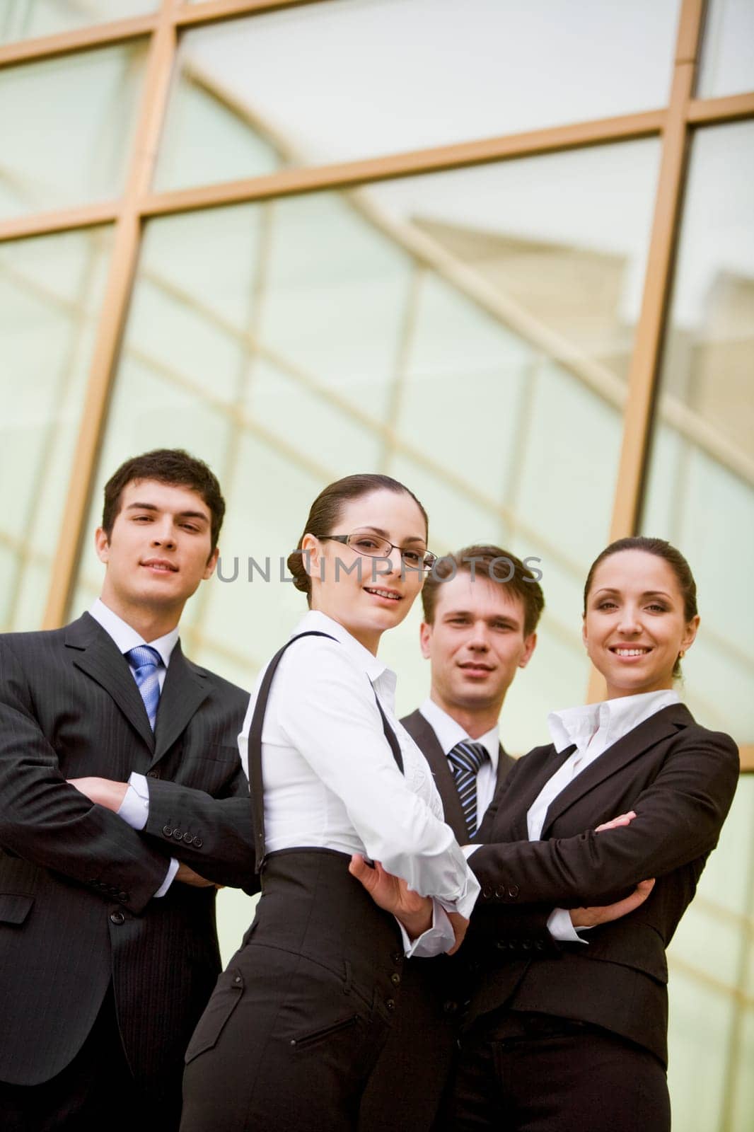 Portrait of well-dressed business partners with their arms crossed looking at camera and smiling