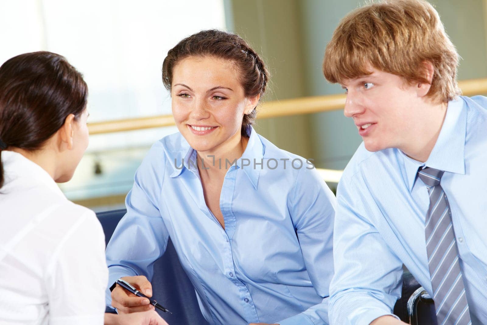 Portrait of confident business partners interacting with each other