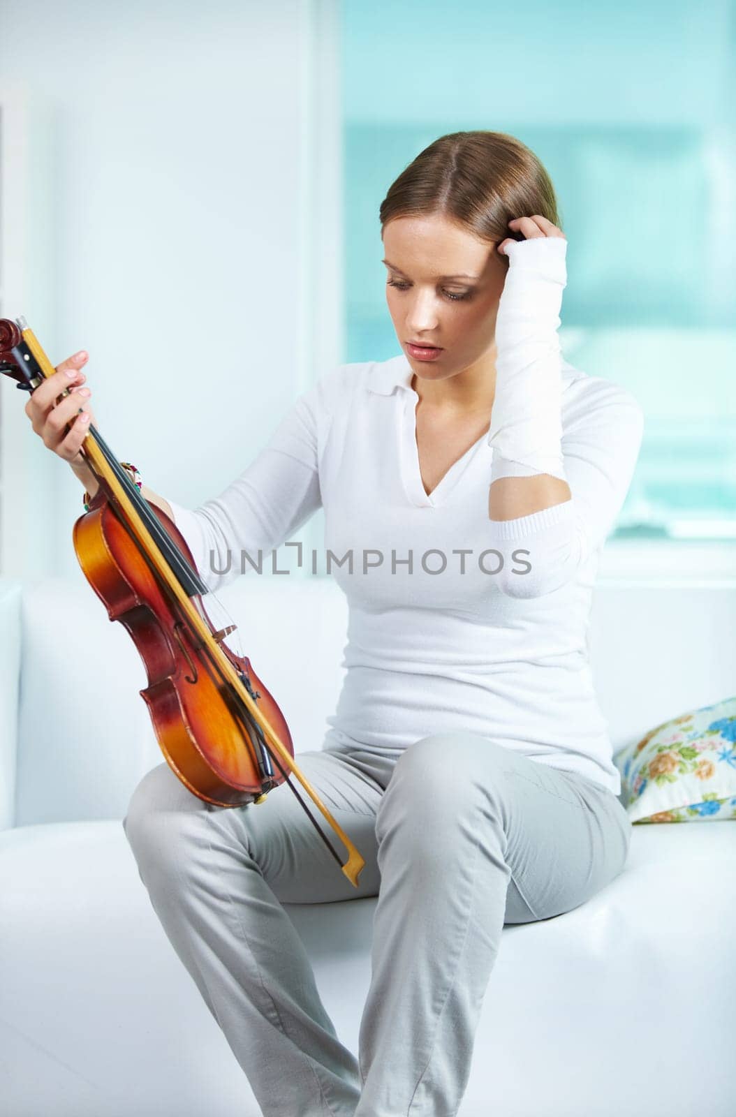 Portrait of a young female with broken arm holding the violin
