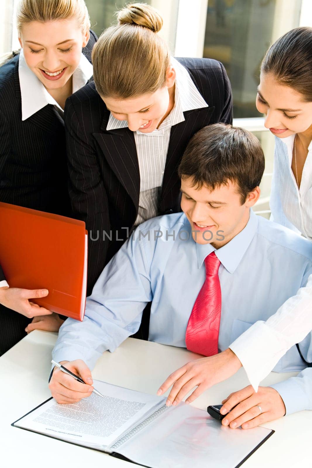Four business people looking at the document with smiles