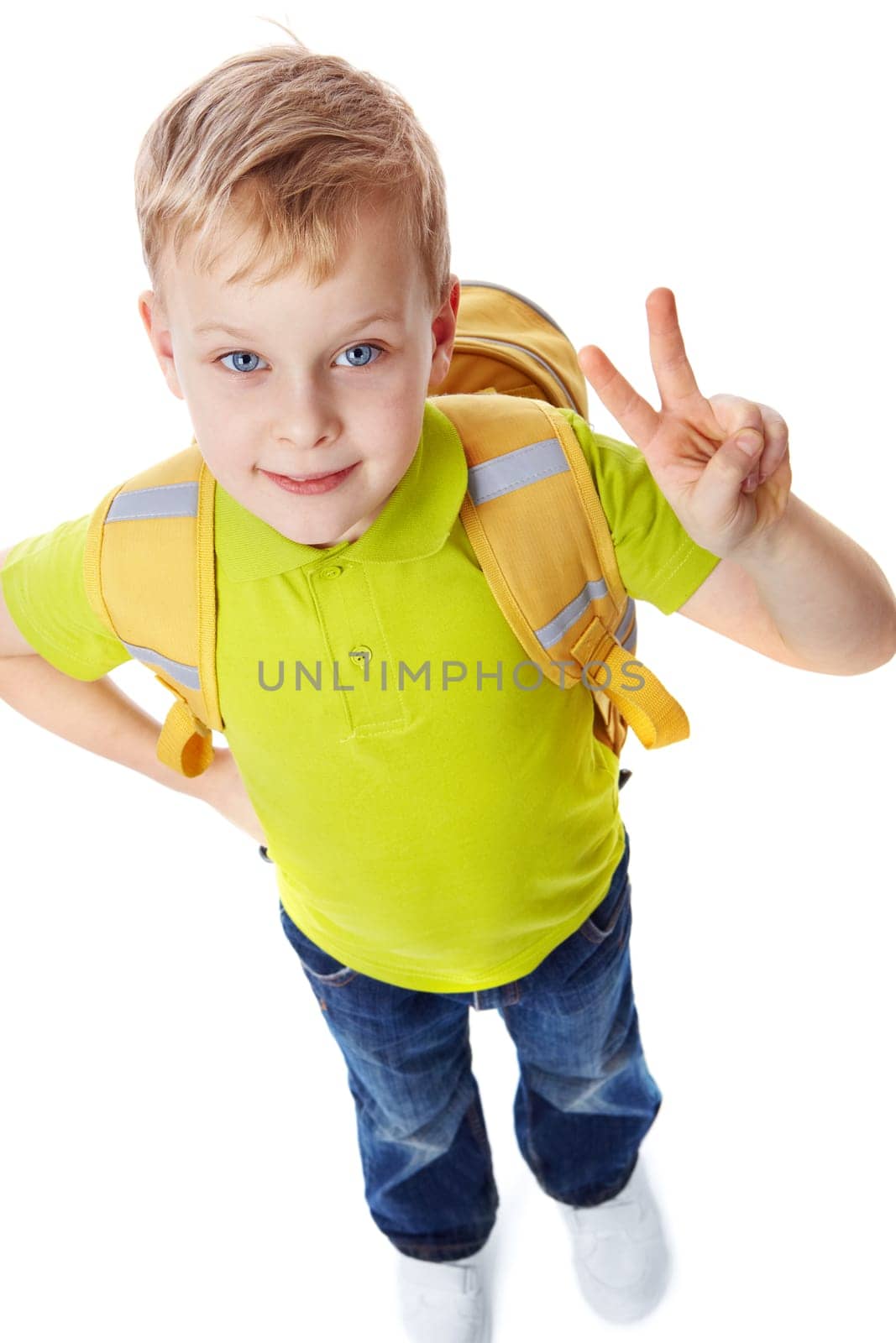 Portrait of a little boy with bag showing victory symbol