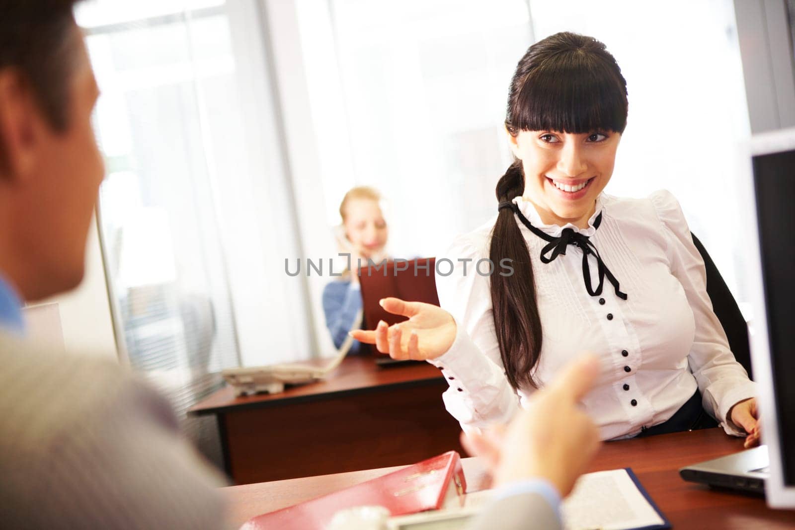 Pretty secretary speaking to boss in the office