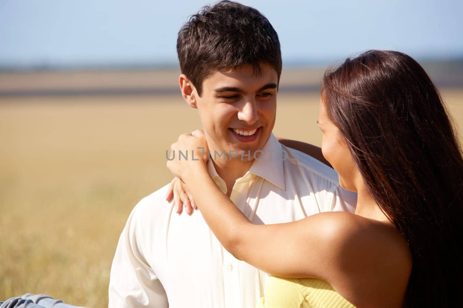 Portrait of man holding beautiful girlfriend while relaxing outside