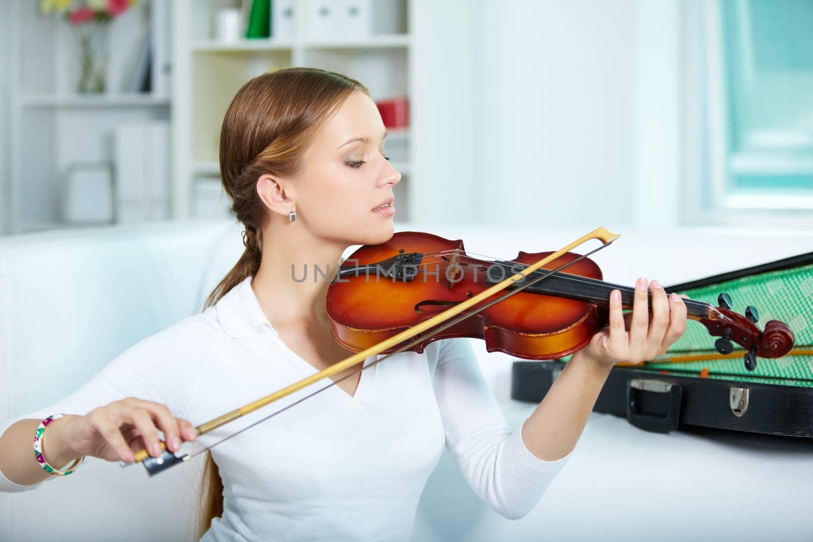 Portrait of a young female playing the violin