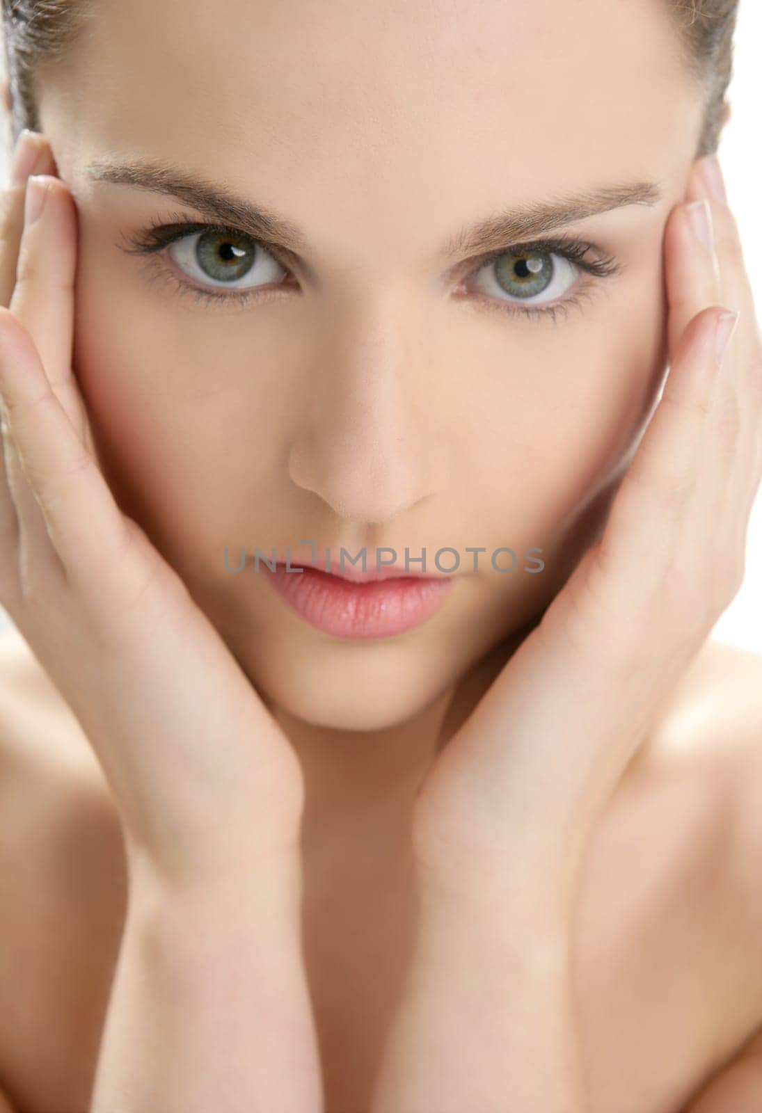Beautiful woman portrait with hands on head isolated on white at studio