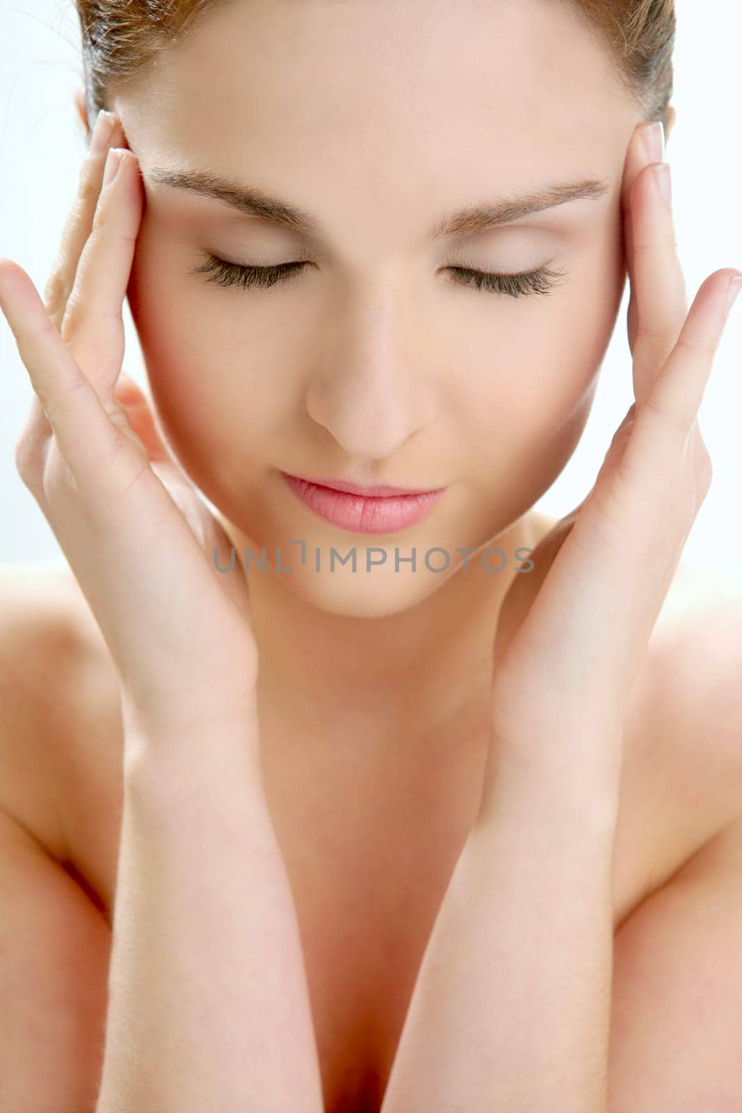 Portrait of young beautiful woman with clean skin at studio