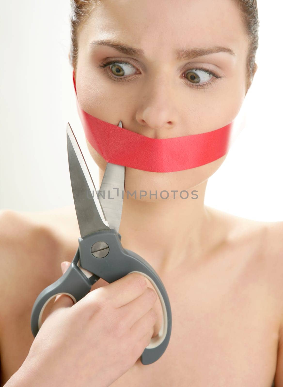 Beautiful woman with red tape on mouth portrait isolated on white