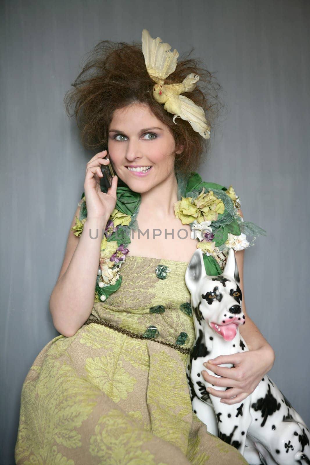 Modern fashion original woman talking phone with dalmatian dog