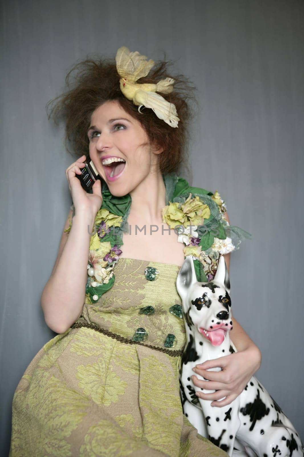 Modern fashion original woman talking phone with dalmatian dog