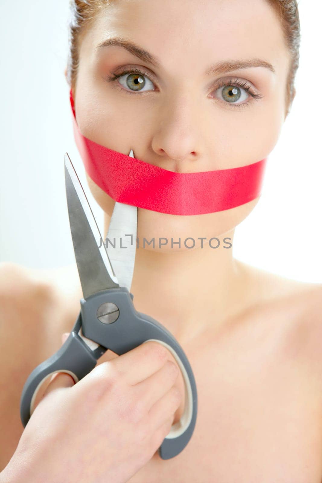 Beautiful woman with red tape on mouth portrait isolated on white