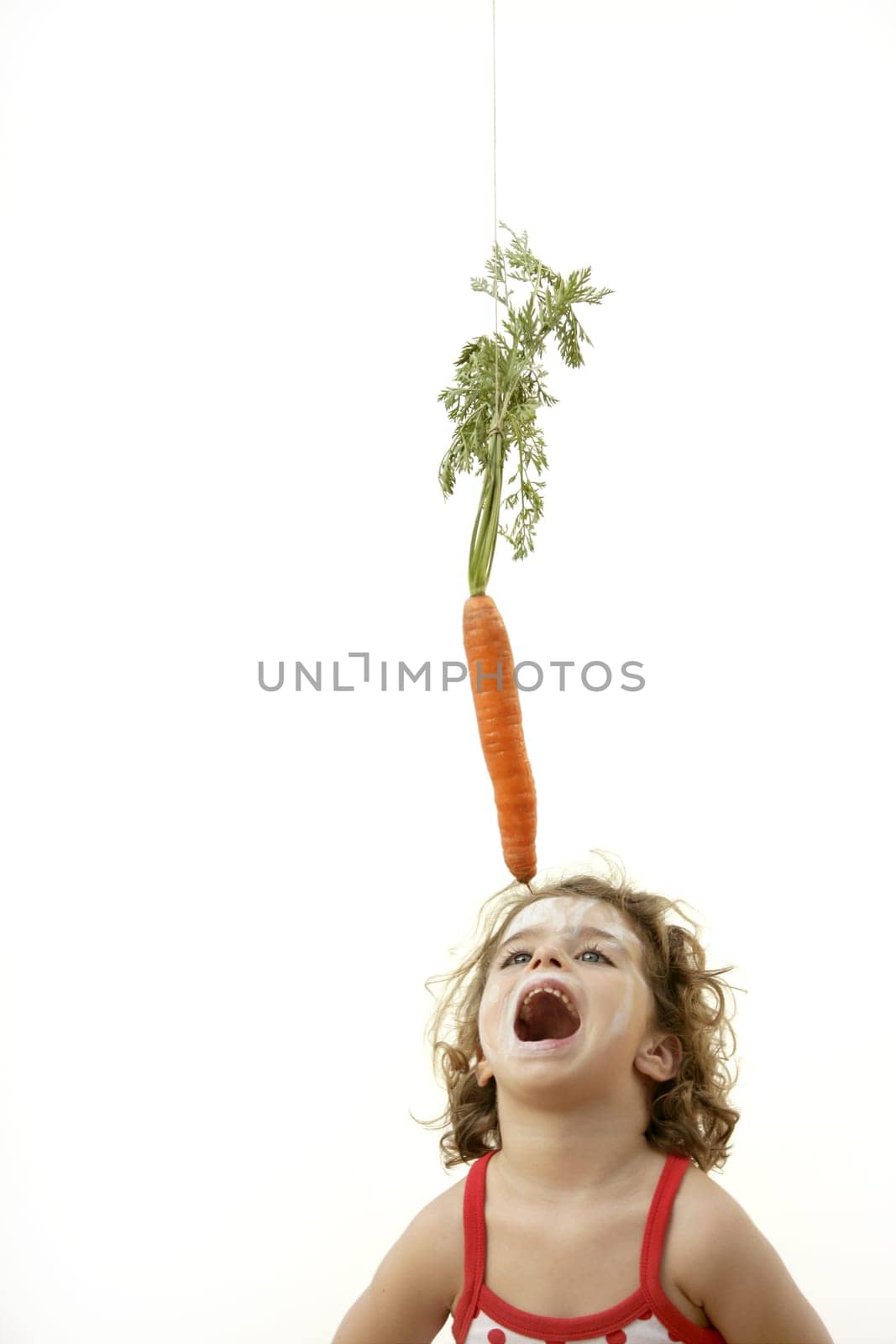 Girl jumping to eat the carrot rabbit trap with open mouth