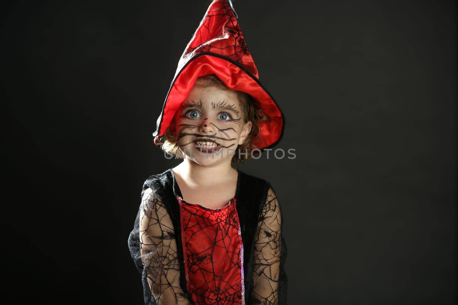 Toddler beautiful witch girl wearing halloween costume and make up